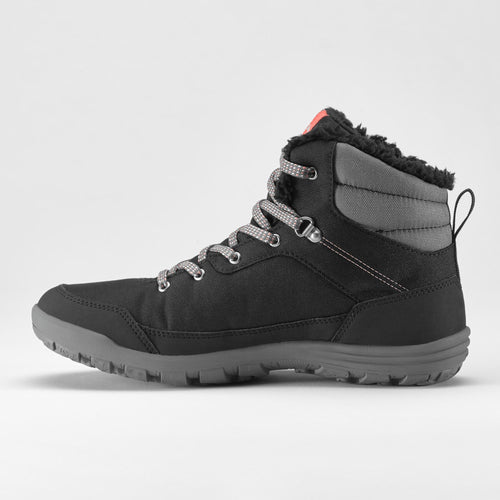 A photo of the Women's Warm and Waterproof Hiking Boots - SH100 MID in use