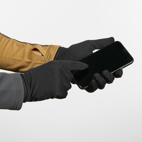 A photo of the Adult Mountain Backpacking Silk Liner Gloves - MT 500 Black in use