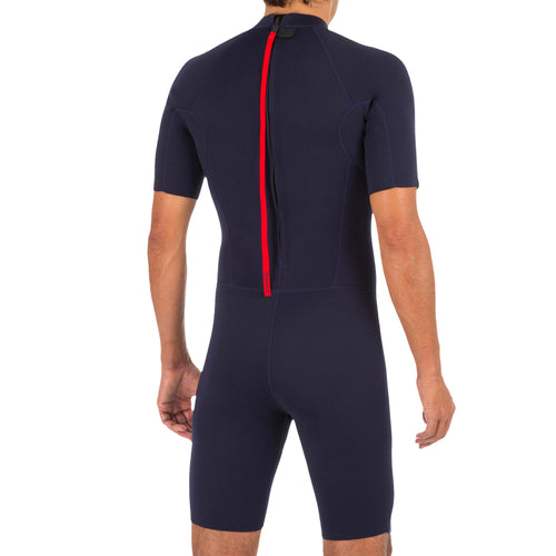 A photo of the 100 men's 1.5mm neoprene Shorty Surfing wetsuit - navy blue in use