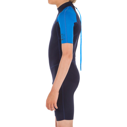 A photo of the Olaian 100 Neoprene Springsuit Surfing Wetsuit Back Zip Shorty 1.5mm Kids in use