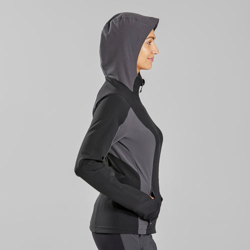 A photo of the Women's Mountain Backpacking Wind Jacket MT900 - black in use