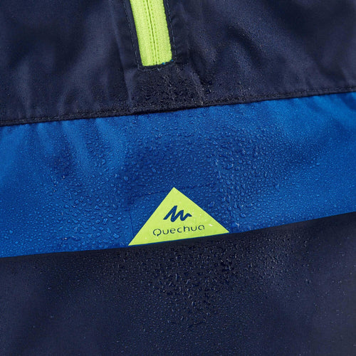 A photo of the Quechua MH100 Waterproof Hiking Jacket Kids' in use