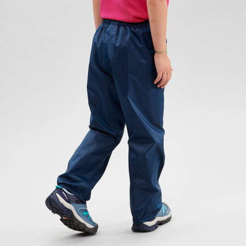 A photo of the Quechua MH100 Waterproof Hiking Overpants Kids' in use