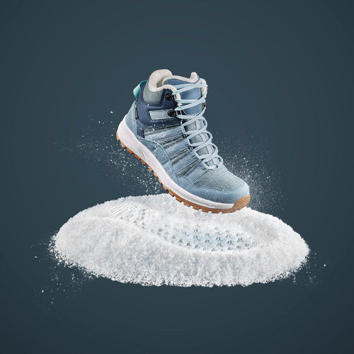 A photo of the Women's warm waterproof snow hiking shoes - SH500 Mid in use