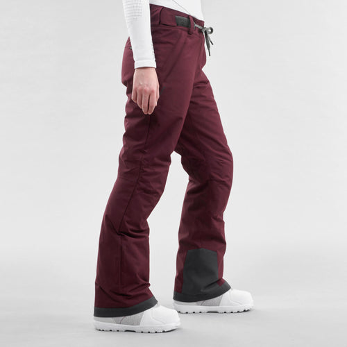 A photo of the Women's skiing and snowboarding Pants 100 burgundy in use