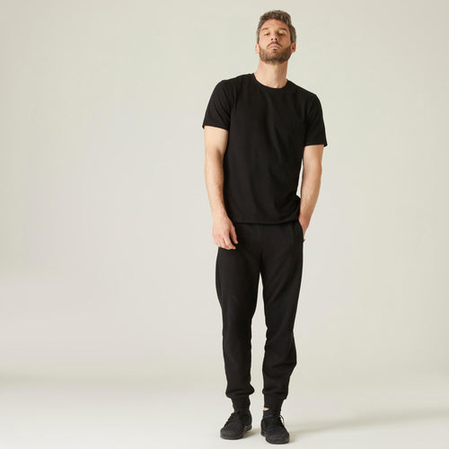 A photo of the Nyamba 500 Stretch Cotton Fitness T-Shirt Men's in use