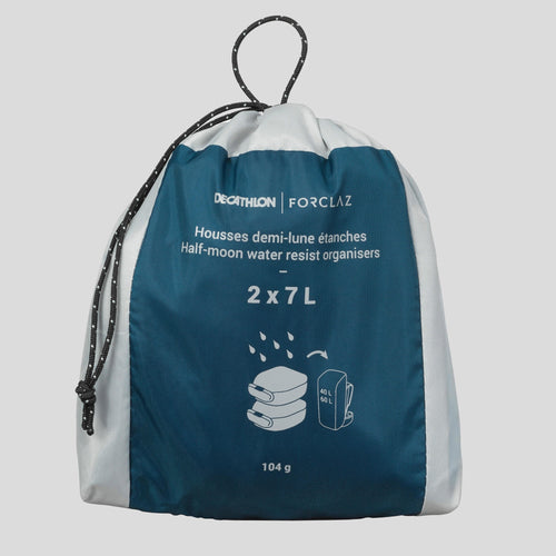 A photo of the Forclaz 7 L Waterproof Half-Moon Hiking Storage Covers 2-Pack in use
