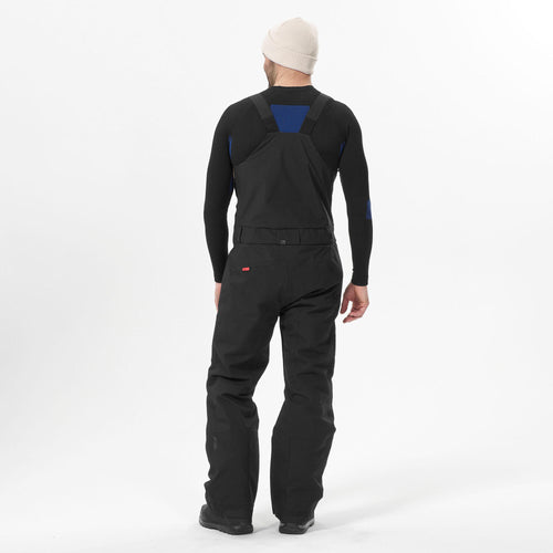 A photo of the Men's Waterproof Snowboard Salopette Pants SNB 900 UP - Black in use