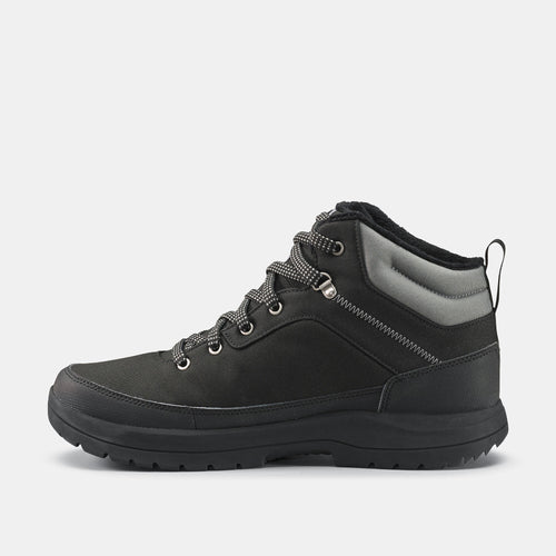 A photo of the Men's warm and waterproof hiking boots - SH100 Mid-height in use