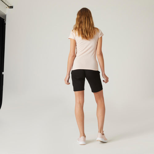 A photo of the Women's Straight-Cut Fitness Shorts with Pockets 500 - Black in use
