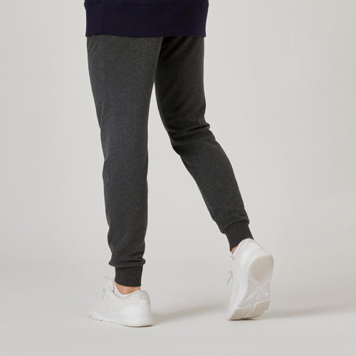 A photo of the Men's Slim-Fit Fitness Jogging Bottoms 500 - Dark Grey in use