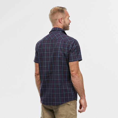 A photo of the Forclaz Men's Travel 100 Short Sleeve Hiking Shirt in use