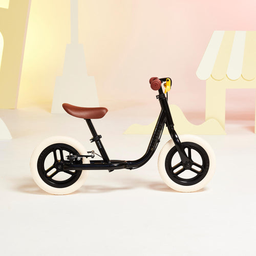 A photo of the Kids Balance Bike Runride 500 Black 10 inch 2-4 years in use