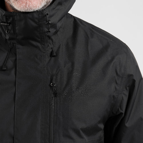 A photo of the Quechua Men's NH500 Imper Waterproof Rain Jacket in use