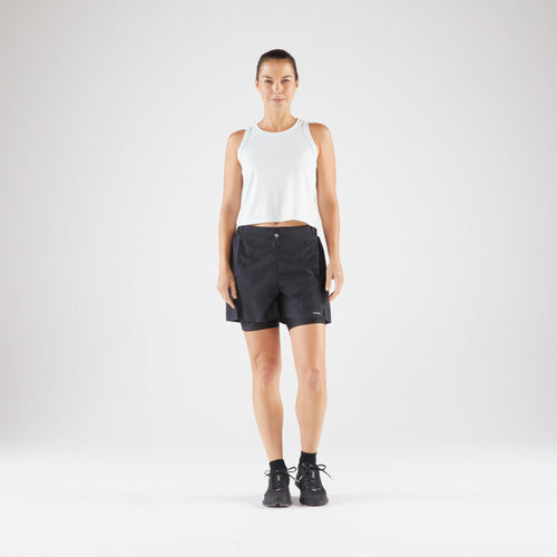 A photo of the Kiprun Women's Run 500 2-in-1 Compression Running Shorts in use