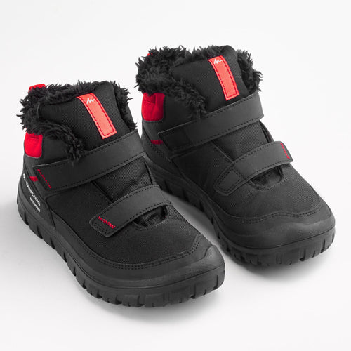 A photo of the SH100 Warm Waterproof Rip-Tab Hiking Boots Kids' in use