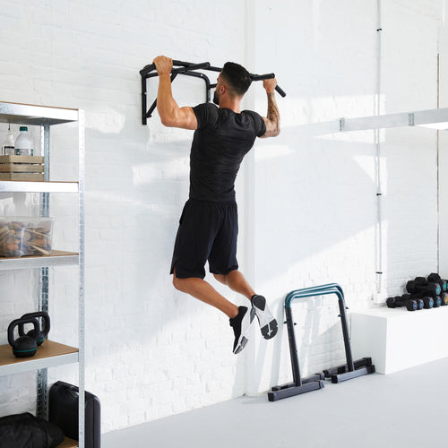 A photo of the Compact Wall-Mounted Pull-Up Bar in use