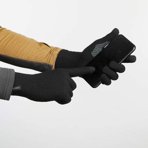 A photo of the Trek 500 Seamless Backpacking Liner Gloves in use