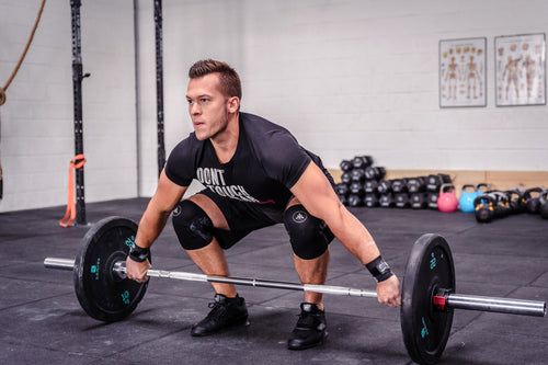 A photo of the Domyos 44 lb Weightlifting Olympic Bumper Plate in use