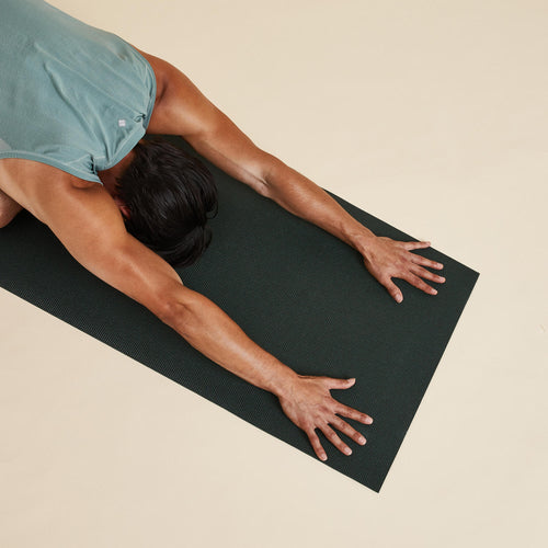 A photo of the Essential Yoga Mat 172CM X 58CM X 4MM - Dark Green in use