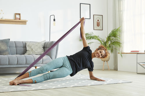 A photo of the Nyamba Rubber Pilates Resistance Band 6 lbs in use