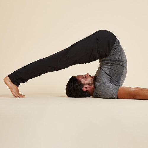 A photo of the Domyos Woven Power Yoga Pants Men's in use