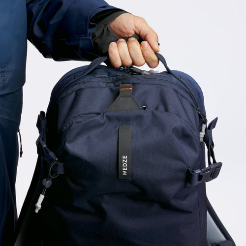 A photo of the Freeride ski snowboard backpack - FR 500 DEFENSE L / XL - Navy blue in use