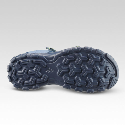 A photo of the Quechua MH100 Hiking Sandals Kids' in use
