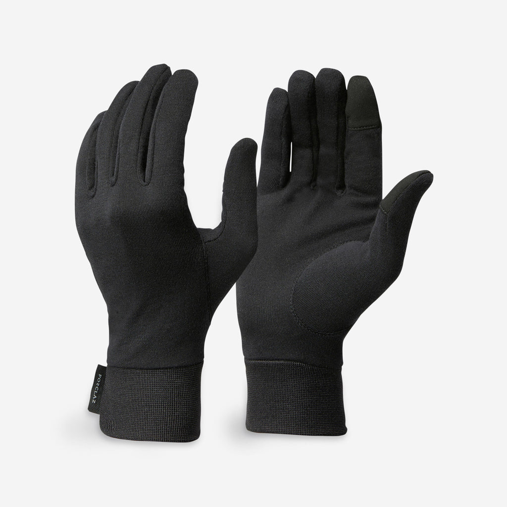 Pair of black gloves on a light gray background