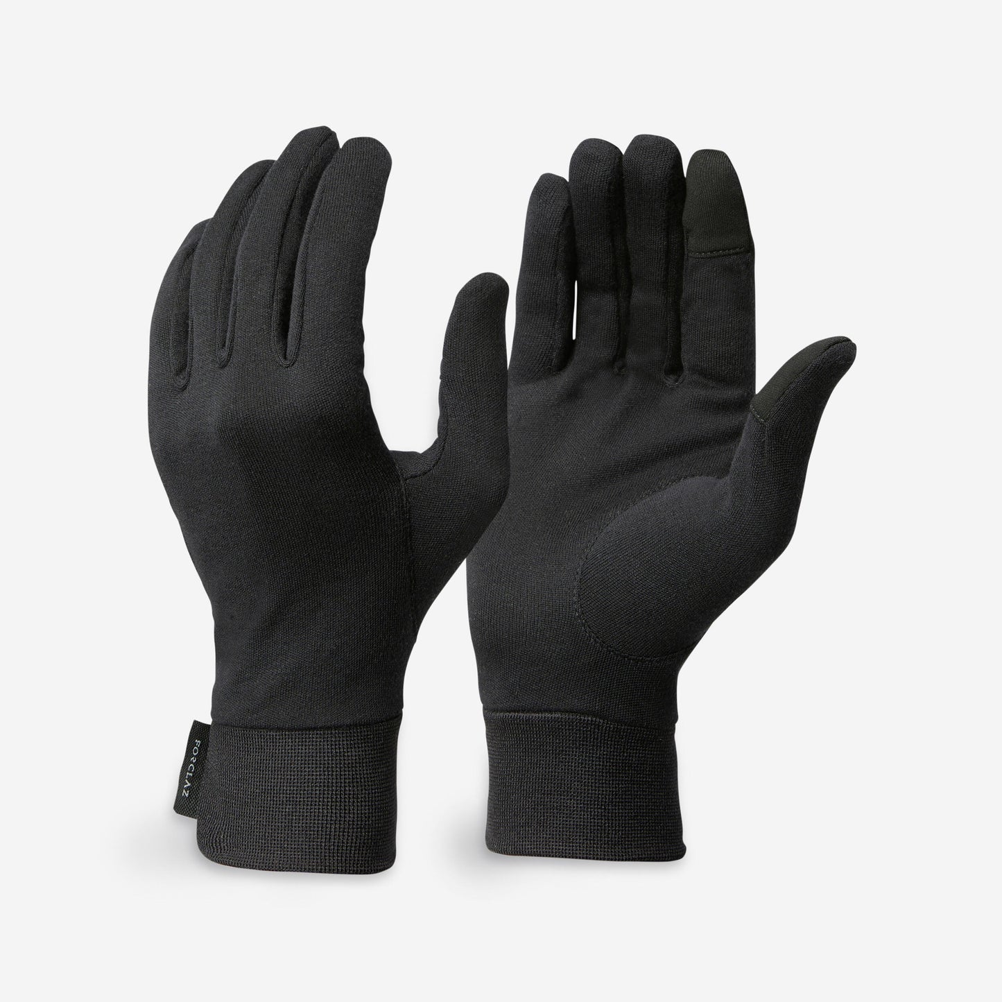 Pair of black gloves on a light gray background