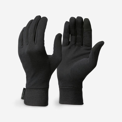 Pair of black gloves on a light gray background