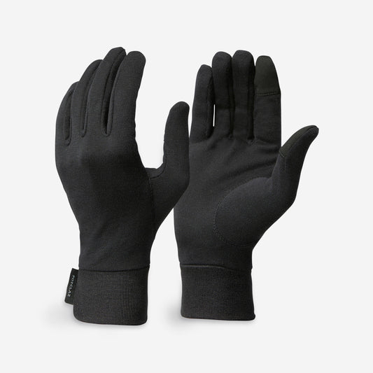 Pair of black gloves on a light gray background