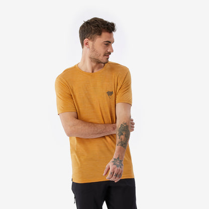 Man wearing a mustard yellow t-shirt with a small logo on a white background