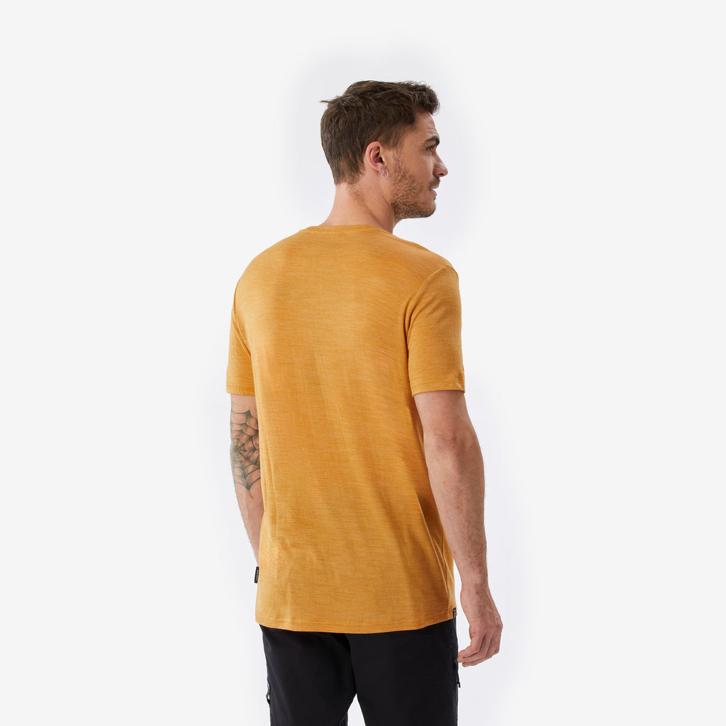 Man wearing a mustard yellow t-shirt on a white background