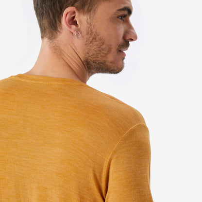 Man wearing a mustard yellow shirt against a white background