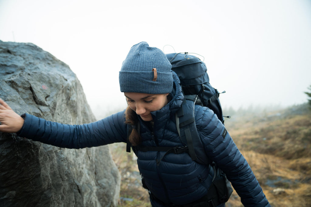 Person hiking with a backpack on a rocky trail