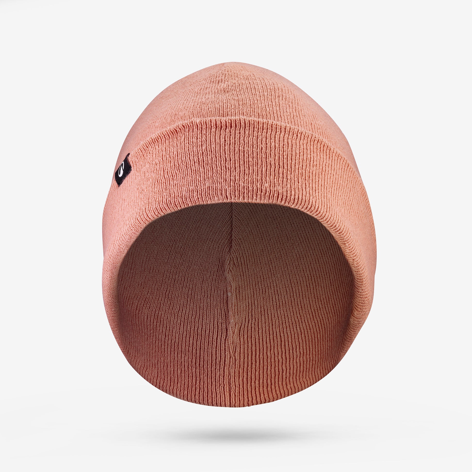 Beige beanie hat on a light gray background