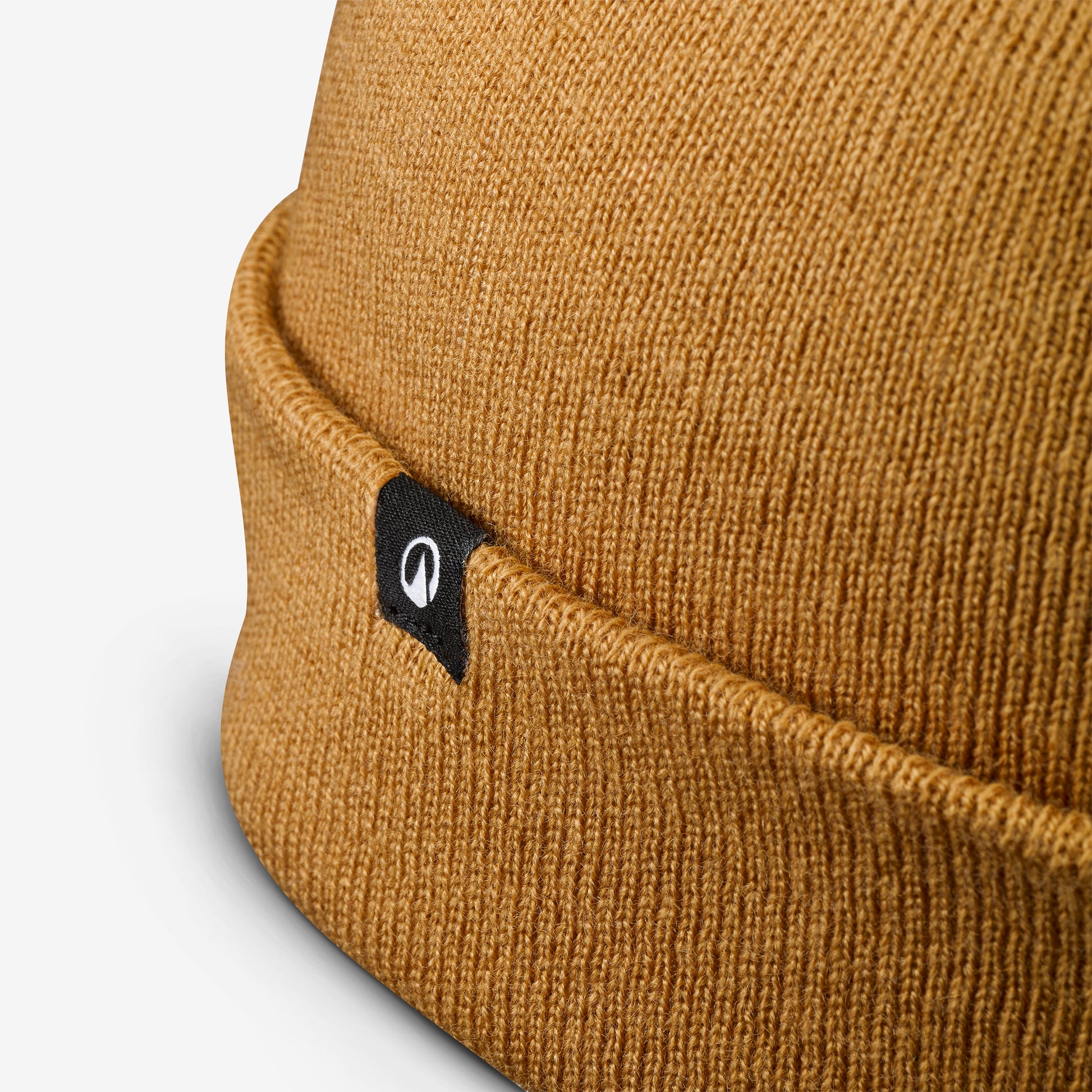 Close-up of a brown beanie with a brand logo on a light gray background